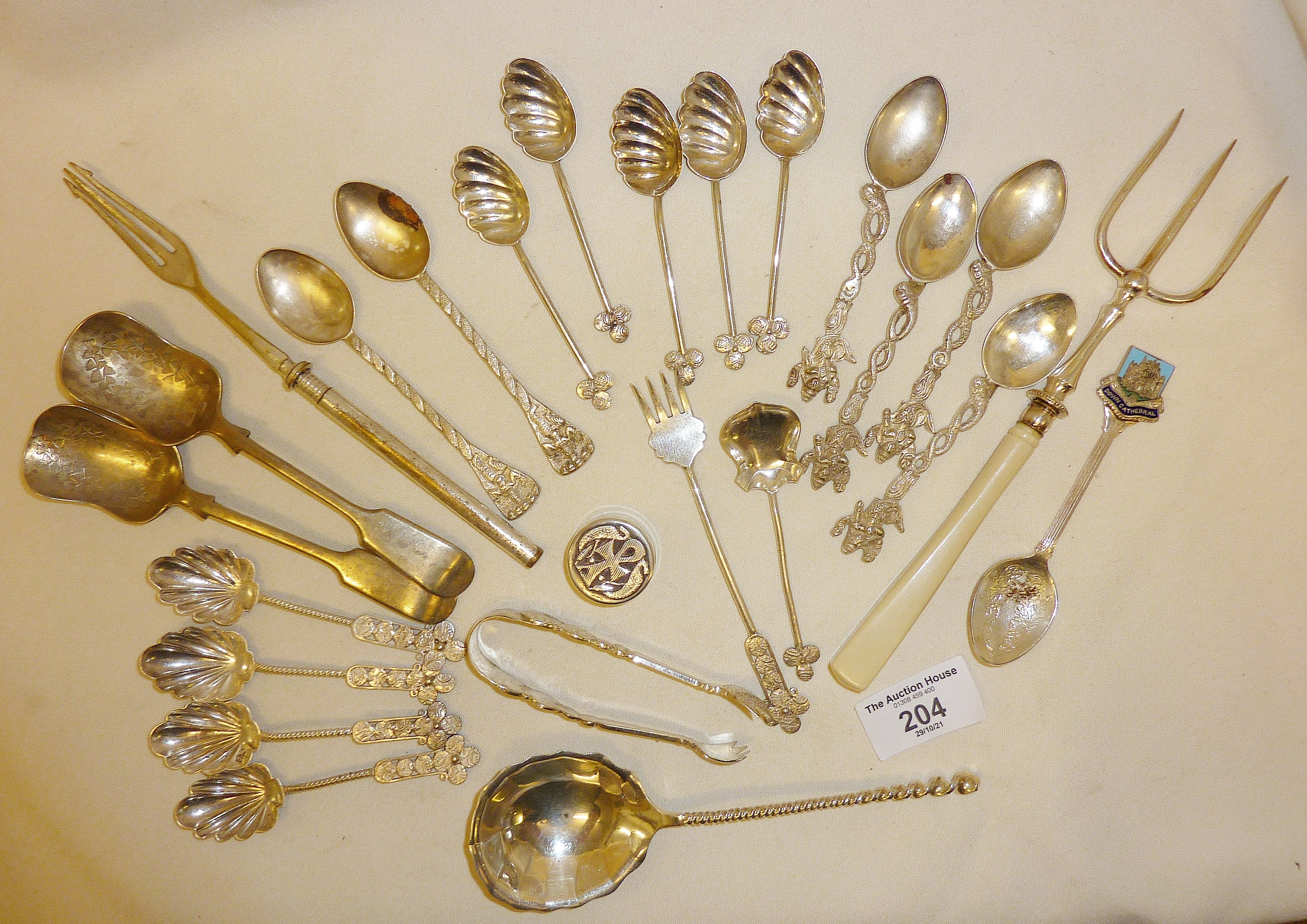 Silver plate and white metal spoons and other cutlery, including one larger spoon with twisted