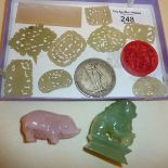Eight Chinese carved jade plaques and a Hong Kong silver coin, etc.