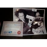 Signed black and white photo of a young Ken Dodd with giant jam butty! Together with COA