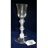 Wine glass with flared conical bowl on triple knopped multi spiral air twist stem and conical foot
