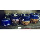 Four Victorian pottery tobacco jars, together with an Art Nouveau patterned Ionian pottery tobacco