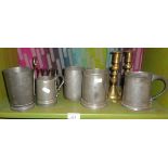 Five various old pewter tankards, a toast rack and a pair of brass candlesticks