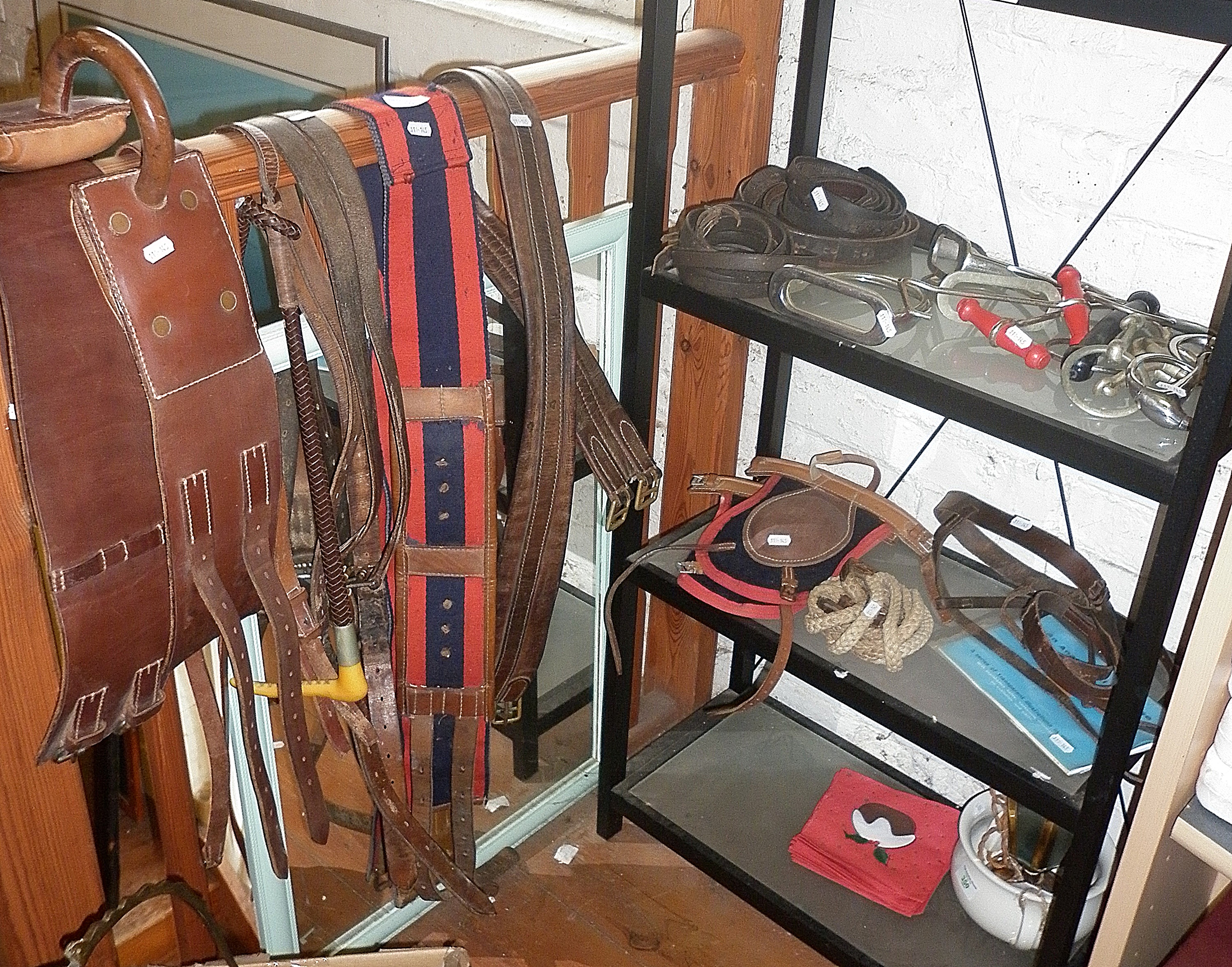 Assorted horse riding tackle, inc. girth straps, bits and stirrups, etc.