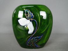 Anita Harris - an Anita Harris vase decorated with white flowers,