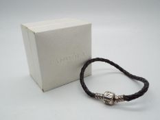 A Pandora silver and leather bracelet All items must be paid for and collected by close of business