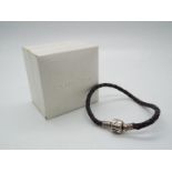 A Pandora silver and leather bracelet All items must be paid for and collected by close of business