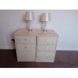 A pair of modern three drawer bedside cabinets with a matching pair of bedside / table lamps