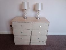 A pair of modern three drawer bedside cabinets with a matching pair of bedside / table lamps