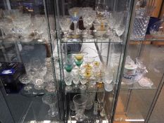 A large quantity of glassware comprising decanters, wine glasses, vases and similar,