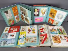 Four Christmas / Greeting Card Albums containing postcards, Christmas cards, birthday cards.