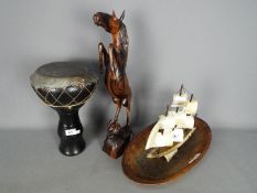Lot to include a tribal drum, wooden carving of a horse and monkey, wooden bowl and similar.