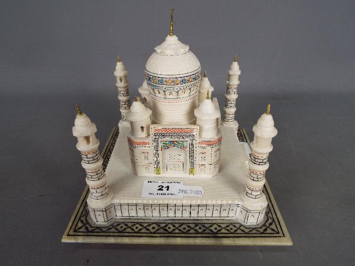 An alabaster model depicting the Taj Mahal with hand painted, coloured detailing,