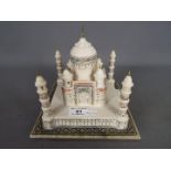 An alabaster model depicting the Taj Mahal with hand painted, coloured detailing,