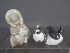Lladro - Two Lladro figurines comprising an Eskimo with polar bear cub # 1195 and a panda bear with