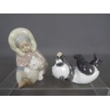 Lladro - Two Lladro figurines comprising an Eskimo with polar bear cub # 1195 and a panda bear with