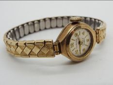 A lady's 9ct gold cased wristwatch on an Excalibur 7 expanding bracelet,