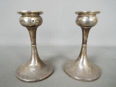 A pair if Edward VII hallmarked silver candlesticks, Birmingham assay 1902, sponsors mark for S.