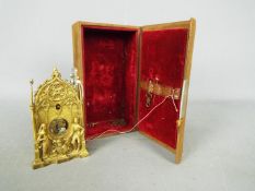 An early 19th century, good quality miniature cast brass Gothic styled zappler clock,