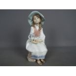 Lladro - A Lladro figurine entitled 'Daydreams' # 6400, depicting a young girl holding a dog,