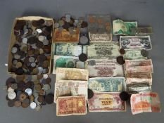 A collection of UK and foreign coins and banknotes.