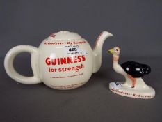 Breweriana - a ceramic teapot decorated with Guinness advertising slogans and an ostrich figurine