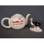 Breweriana - a ceramic teapot decorated with Guinness advertising slogans and an ostrich figurine