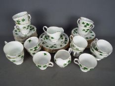 A collection of Colclough tea wares in the Ivy Leaf pattern # 8143, in excess of fifty pieces.