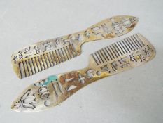 A pair of Egyptian combs decorated with hieroglyphics and other marks, stamped,