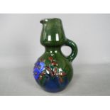 A ceramic Elton Ware green jug,