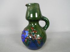 A ceramic Elton Ware green jug,