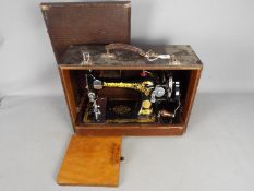 A decorative Singer sewing machine in carry case, serial number EB943692.