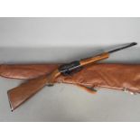 A Rogers, Arkansas Powerline 922 pump action .22 cal air rifle in carry case, serial number G903478.
