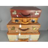 Four pieces of vintage luggage.