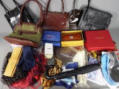 A collection of lady's handbags, silk scarves, purse and similar.