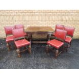 A highly carved extending dining table and six matching chairs,