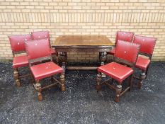 A highly carved extending dining table and six matching chairs,