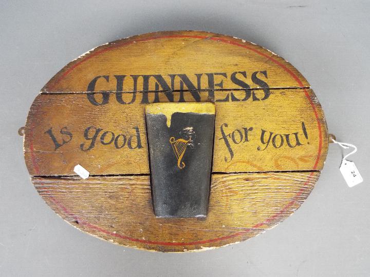 Breweriana -an oval Guinness advertising sign, approximately 37 cm x 48 cm.