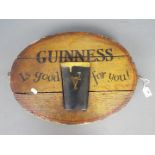 Breweriana -an oval Guinness advertising sign, approximately 37 cm x 48 cm.