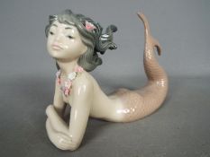 Lladro - A Lladro figurine depicting a mermaid entitled 'Fantasy' # 1414, approximately 11 cm (h).