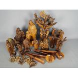A collection of carved wood figures and similar, many religious themed.