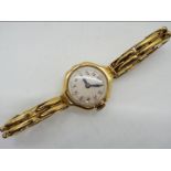 A lady's 18ct gold cased wristwatch on expanding bracelet stamped 18ct,