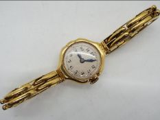 A lady's 18ct gold cased wristwatch on expanding bracelet stamped 18ct,