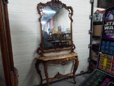 A highly carved console table with marble top and matching mirror,