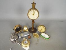 A collection of travel clocks to include and Ebel and two modern pocket watches.