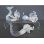 Lladro - A set of three Lladro matte white porcelain figurines depicting mermaids comprising