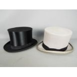 Two top hats, one in grey marked 7 3/8 to the interior, the other a folding example,