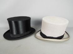 Two top hats, one in grey marked 7 3/8 to the interior, the other a folding example,