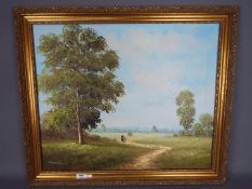 A framed oil on canvas landscape, signed lower left by the artist, approximately 50 cm x 60 cm.