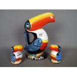 Breweriana - a Guinness Toucan money bank, 21 cm (h) and a pair of salt and pepper shakers.