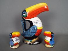 Breweriana - a Guinness Toucan money bank, 21 cm (h) and a pair of salt and pepper shakers.
